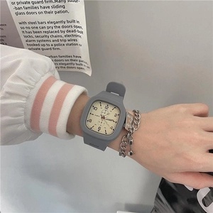 Close-up of a square grey silicone waterproof sports watch worn on a girl's wrist
