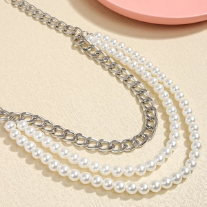Detail showing multi-layer silver metal chain and white pearls for elegant dress belt