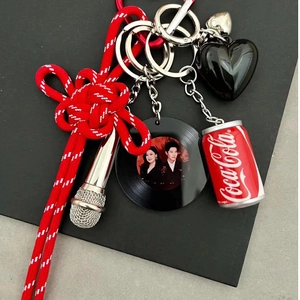 Chinese knot keychain with microphone heart and vinyl record charms on black background