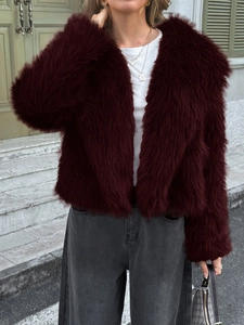 Detail of soft burgundy faux fur jacket texture and plush material in daylight