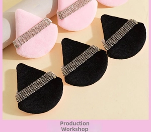 Macro detail of triangle makeup puffs with luxury rhinestone straps in pink and black