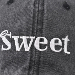 Washed cotton baseball cap with white Sweet embroidery detail in dark gray finish
