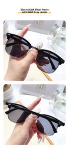 Detail of classic semi-rimless sunglasses with shiny black frame and silver metal accents