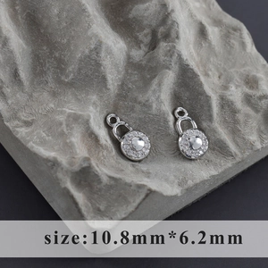 Detailed close-up of rhodium-plated lock pendant with zircon pave measuring 10.8mm x 6.2mm