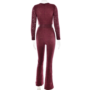 Detail of wine red lace jumpsuit with long sleeves, matching belt and flared pants