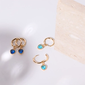 Elegant heart-shaped crystal drop earrings in gold finish with blue stones