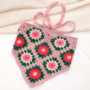 Close-up of pink handmade crochet floral triangle headscarf with knit flower details