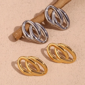 Macro detail of geometric water ripple matte earrings in 18K gold and silver finish
