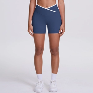 Detailed view of high-waisted navy yoga shorts with white criss-cross elastic waistband