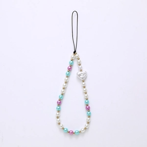 Beaded heart phone strap with white pearls and gold accents on a clean white backdrop