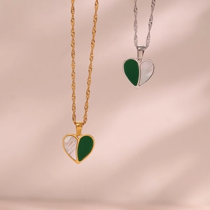Detailed close-up of gold and silver heart necklaces with green and shell inlay