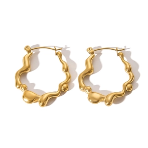 Detailed view of irregular wavy 18K gold-plated stainless steel hoop earrings with glossy finish