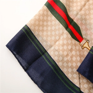 Macro detail of navy blue and beige plaid scarf showing high-quality fabric texture