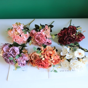 Assorted silk rose bouquets in pink, red, and purple for elegant home wedding decor