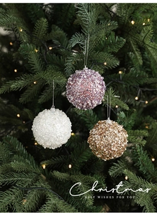 Detail of 8cm Christmas foam ornaments with pearls and sequins hanging on a tree branch