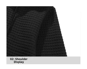 Close-up of black waffle texture knit fabric on shoulder detail of men's hoodie