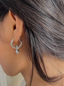 Silver teardrop hoop earring on model showing real size and elegant hang