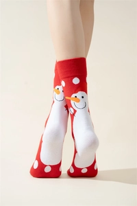 Detail of red Christmas socks with white snowman patterns and polka dots on a model