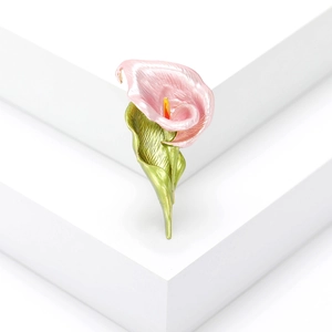 Elegant pink and green enamel Calla Lily brooch on a white minimalist display stand