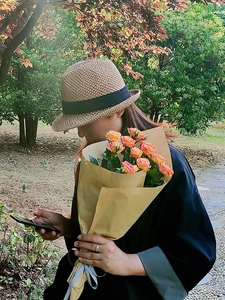 Handwoven light brown straw hat with black ribbon edge for summer travel fashion