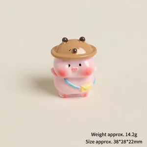 Detail view of mini resin pink pig figurine with bear hat and yellow bag accessory