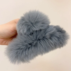 Detailed close-up of a plush grey faux fur hair claw clip for autumn and winter styles