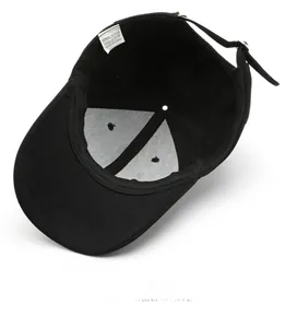 Detail view of the black baseball cap's inner structure with an adjustable strap