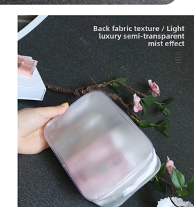 Detail view of semi-transparent waterproof PVC toiletry bag with matte fabric texture