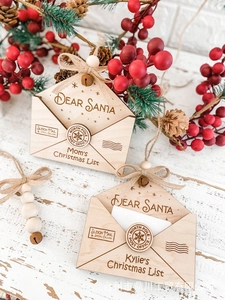 Detail of wooden Christmas envelope ornament with Dear Santa engraving and jute bow