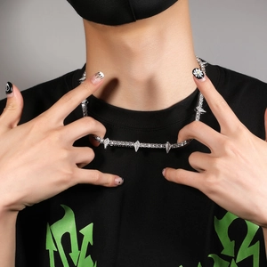 Hip hop silver necklace with spiked design and faux diamonds worn by a male model