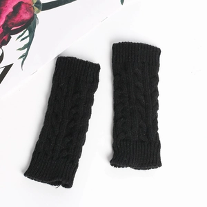 Detailed view of black cable knit fingerless gloves with soft acrylic texture for winter
