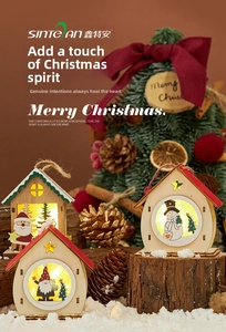 Three LED Christmas wooden house ornaments with warm glow and festive snow backdrop