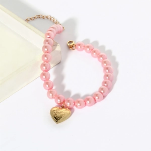 Detail of pink pearl pet necklace with golden heart lock pendant and lobster clasp closure