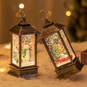 Vintage silver Christmas lantern with snowman and tree inside, filled with sparkling glitter