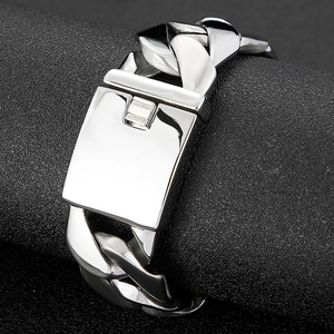 Macro shot of polished silver Cuban chain bracelet with a sleek rectangular clasp for men