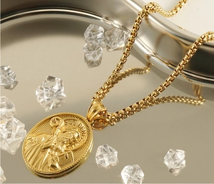 Detailed close-up of 18k gold-plated Saint Benedict religious pendant with box chain