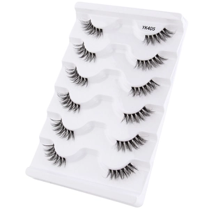 Detailed view of 5 pairs of natural black half-lashes on tray for cat-eye look