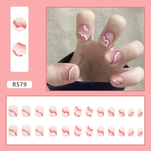 Close-up of R579 press-on nails with pink, white, and red wavy patterns in a 24-piece set