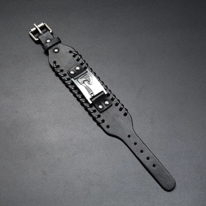 Detail of Viking battle axe black braided leather bracelet with rivet accents and buckle