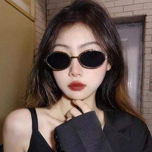 Vintage oval metal frame sunglasses with glitter trim and black lenses for women
