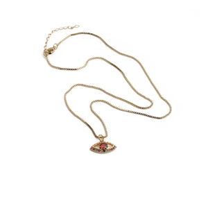 Detailed macro view of a gold box chain with a rainbow zircon evil eye pendant
