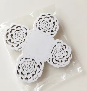 Detailed laser-cut white floral paper hollow candy box decoration piece in a clear bag