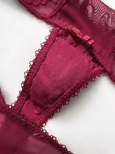 Nahaufnahme weinroter Spitzen-T-String mit Mesh und Details der Baumwollzwickelnaht