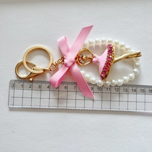 Detailed view of the ballet girl keychain with scale showing length of about 15 cm