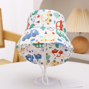 Detail of kids sun hat featuring colorful cartoon car prints and adjustable wind strap
