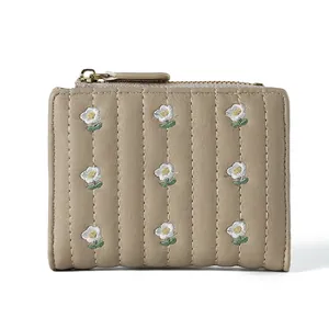 Minimalist women's short leather wallet in beige with vertical quilting and daisy embroidery