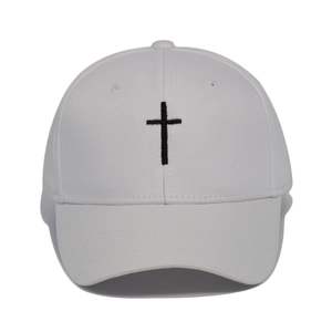 Close-up of high-quality black cross embroidery on a classic white cotton baseball cap