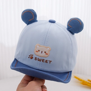Detail of sweet bear embroidery and 3D ears on a blue cotton baby baseball cap