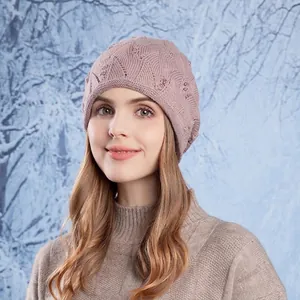 Women's pink knit beanie with pearl decor and wavy pattern in a snowy winter scene
