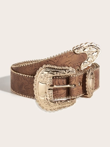 Close-up of brown western leather belt with gold floral buckle and beaded trim details